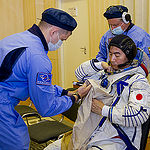 In the Integration Facility at the Baikonur Cosmodrome in Kazakhstan, Expedition 44 crewmember Kimiya Yui of the Japan Aerospace Exploration Agency suits up in his Sokol launch and entry suit July 11 as part of a fit check dress rehearsal. Yui, Kjell Lindgren of NASA and Oleg Kononenko of the Russian Federal Space Agency (Roscosmos) will launch July 23, Kazakh time from Baikonur in their Soyuz TMA-17M spacecraft for a five-month mission on the International Space Station. Credit: Gagarin Cosmonaut Training Center