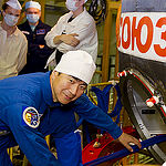 In the Integration Facility at the Baikonur Cosmodrome in Kazakhstan, Expedition 44 crewmember Kimiya Yui of the Japan Aerospace Exploration Agency poses for pictures July 11 prior to entering his Soyuz TMA-17M spacecraft during a fit check dress rehearsal session. Yui, Kjell Lindgren of NASA and Oleg Kononenko of the Russian Federal Space Agency (Roscosmos) will launch July 23, Kazakh time from Baikonur in their Soyuz TMA-17M spacecraft for a five-month mission on the International Space Station. Credit: Gagarin Cosmonaut Training Center