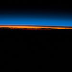 ISS043E193911 (05/14/2015) --- Crew members of Expedition 43 on the International Space Station are treated to the spectacular beauty of the Earth day and night. In this image they captured the dying sun as it creates brilliant orange and red streaks contrasted with the darkening Earth and the still blue night sky.